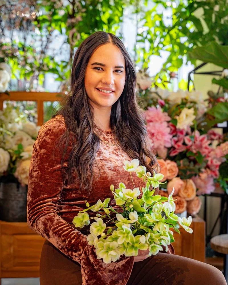 Dayana Muir, a Tipton & Hurst floral designer, holding a flower arrangement